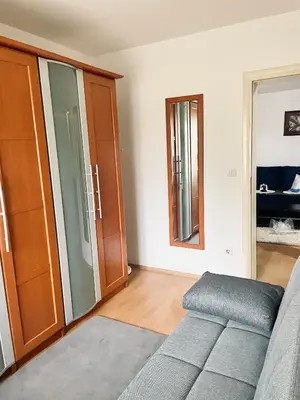 a living room with a couch and a mirror at Apartman Bloom in Novi Grad