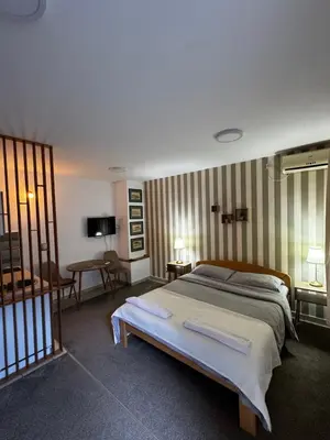 a bedroom with a large bed in a room at Holiday in Belgrade