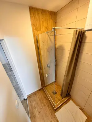 a shower with a glass door in a bathroom at Holiday in Belgrade