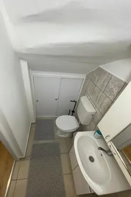 a small bathroom with a toilet and a sink at Holiday in Belgrade