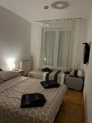a hotel room with two beds and a television at Stepa in Belgrade