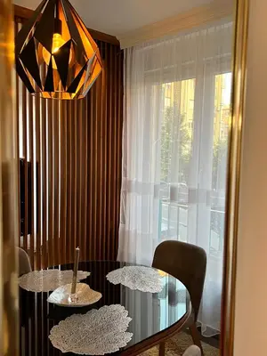 a dining room with a table and chairs and a chandelier at Stepa in Belgrade
