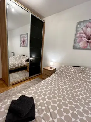 a bedroom with a bed and a large mirror at Stepa in Belgrade