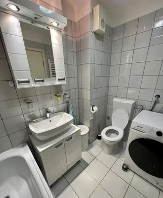 a white bathroom with a sink and a toilet at Stepa in Belgrade