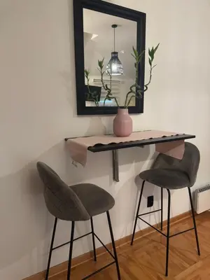 a table and two chairs in a room with a mirror at Gaga Gold in Belgrade