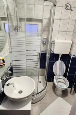 a bathroom with a sink and a toilet and a shower at Gaga Gold in Belgrade