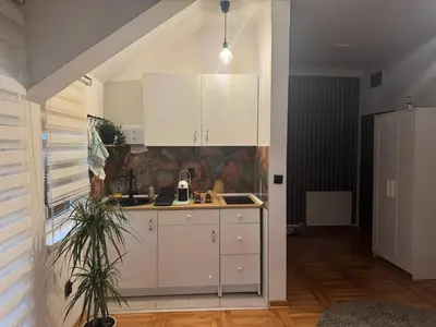 a kitchen with white cabinets and a sink at Gaga Gold in Belgrade