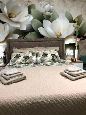 a bedroom with a bed with two towels on it at Studio Lotos in Belgrade