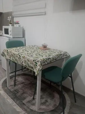 a table with two chairs and a table with a table cloth at Studio Lotos in Belgrade