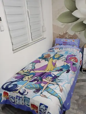 a bedroom with a bed with a mermaid bedspread at Studio Lotos in Belgrade