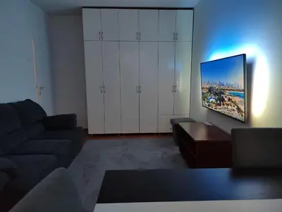 a living room with a couch and a flat screen tv at Lira Beo in Vračar (historical)