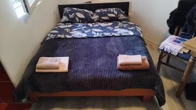 a bed in a room with two towels on it at Small Apartment FREE TRANSPORTATION FROM THE AIRPORT TO THE APARTMENT in Belgrade
