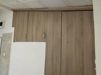a pair of wooden cabinets in a room at Small Apartment FREE TRANSPORTATION FROM THE AIRPORT TO THE APARTMENT in Belgrade