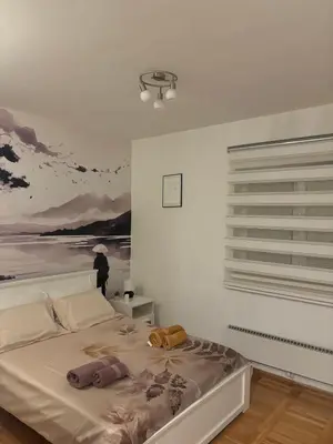 a bedroom with a bed with a painting on the wall at Gaga 1 in Filmski Grad
