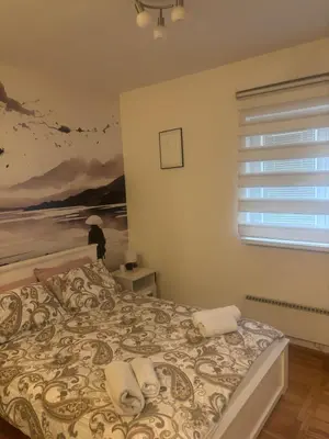 a bedroom with a bed with a painting on the wall at Gaga 1 in Filmski Grad