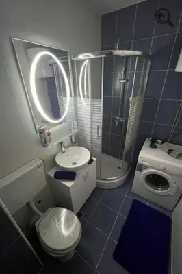 a bathroom with a toilet sink and a shower at Gaga 1 in Filmski Grad