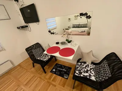a room with a table and two chairs and a mirror at Gaga 1 in Filmski Grad