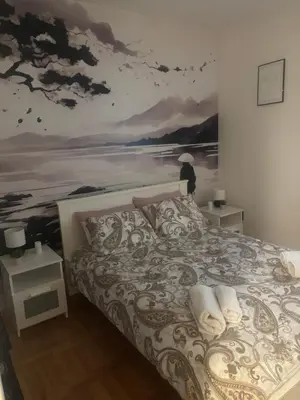 a bedroom with a bed with a painting on the wall at Gaga 1 in Filmski Grad