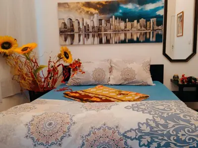 a bedroom with a bed with a painting on the wall at STUDIO Eva in Sajmište