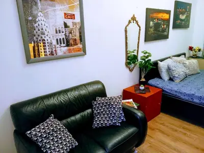 a living room with a couch and a bed at STUDIO Eva in Sajmište