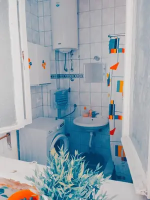 a small bathroom with a toilet and a sink at STUDIO Eva in Sajmište