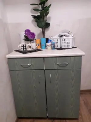 a green cabinet with a white counter top at STUDIO Eva in Sajmište