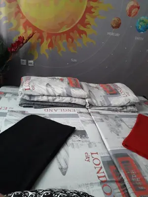 a bed with a comforter and pillows on it at STUDIO Eva in Sajmište