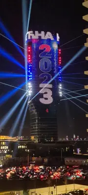 a tall building with blue lights in front of a city at Premium Studio Apartment - Belgrade Waterfront in Sajmište