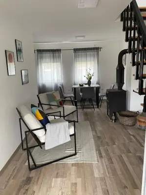 a living room with chairs and a table at Vikendica Fruskogorski kutak in Krušedol