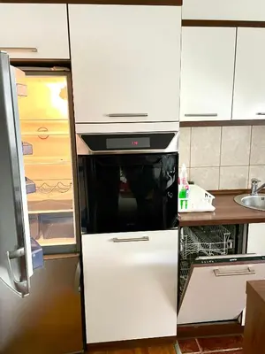 a kitchen with a refrigerator with a microwave at TRIANGLE CITY Apartment 1 in Belgrade