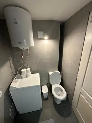 a small bathroom with a toilet and a sink at TRIANGLE CITY Apartment 1 in Belgrade
