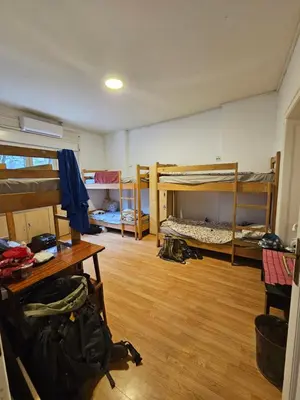 a room with several bunk beds and a wooden floor at The Traveling Theater in Belgrade