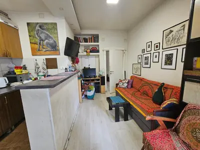 a kitchen and living room with a couch and a counter at The Traveling Theater in Belgrade