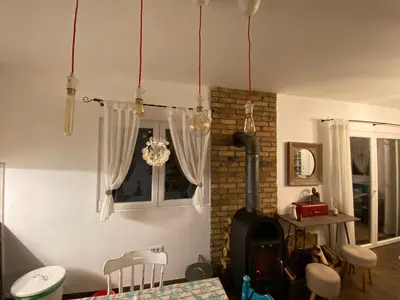 a living room with a fireplace and a stove at Kućica in Velika Remeta
