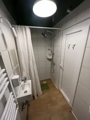 a bathroom with a shower and a sink and a toilet at Cabbage Hostel in Belgrade