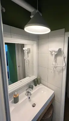 a bathroom with a sink and a mirror at Cabbage Hostel in Belgrade