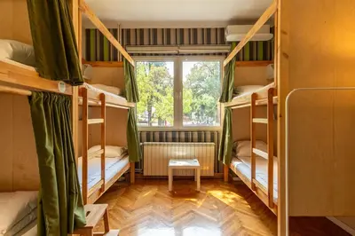 a room with four bunk beds with a window at Cabbage Hostel in Belgrade