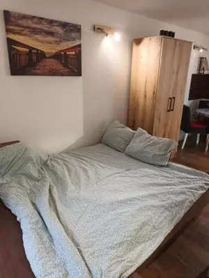 a bed in the corner of a room at Aurora in Zvezdara