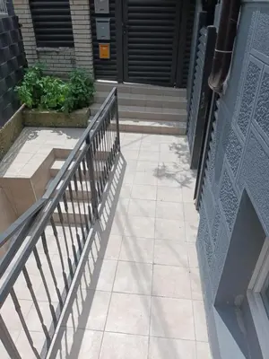 a walkway leading to a door with a metal railing at Aurora in Zvezdara