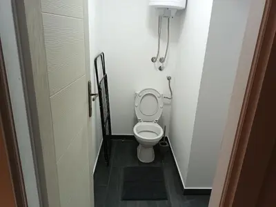 a small bathroom with a toilet in a stall at Aurora in Zvezdara