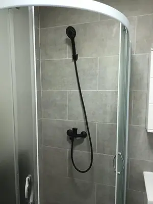 a shower with a shower head in a bathroom at Aurora in Zvezdara