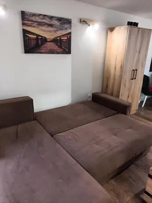 a large bed in a room with a wooden cabinet at Aurora in Zvezdara