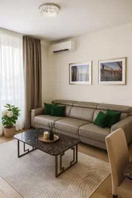 a living room with a couch and a table at ForS Belgrade Waterfront in Belgrade