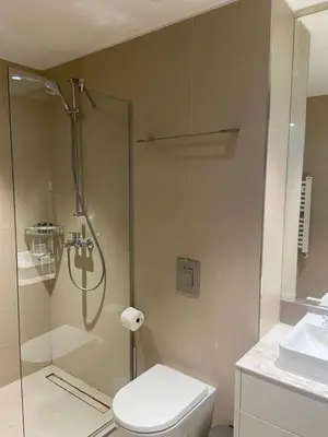 a bathroom with a shower and a toilet and a sink at ForS Belgrade Waterfront in Belgrade