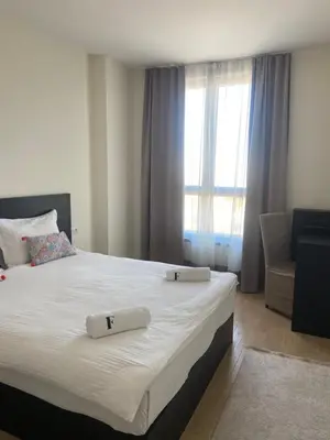 a bedroom with a large bed with two towels on it at ForS Belgrade Waterfront in Belgrade