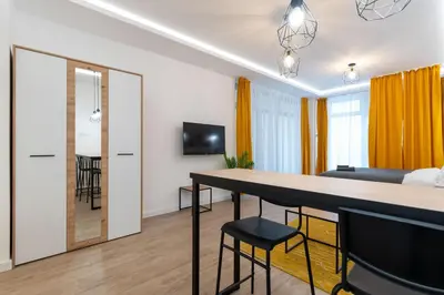 a living room with a kitchen and a dining room at Siva in Fontana