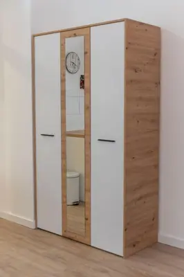 a wardrobe with two doors and a mirror at Siva in Fontana