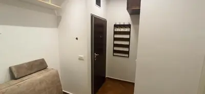 a room with a couch and a door with a shelf at Belgrade St Sava Temple Hram in Belgrade