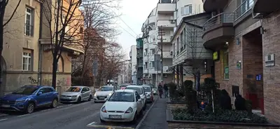 a city street with cars parked on the side of the road at Belgrade St Sava Temple Hram in Belgrade