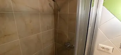 a shower with a glass door in a bathroom at Belgrade St Sava Temple Hram in Belgrade